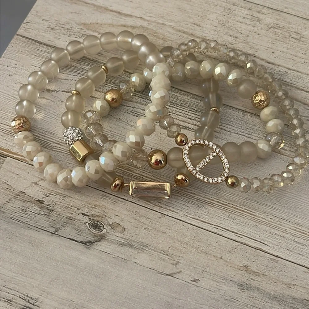 Off White/Smoky Beaded Four Strand Stretchy Gem/Charm Bracelet.